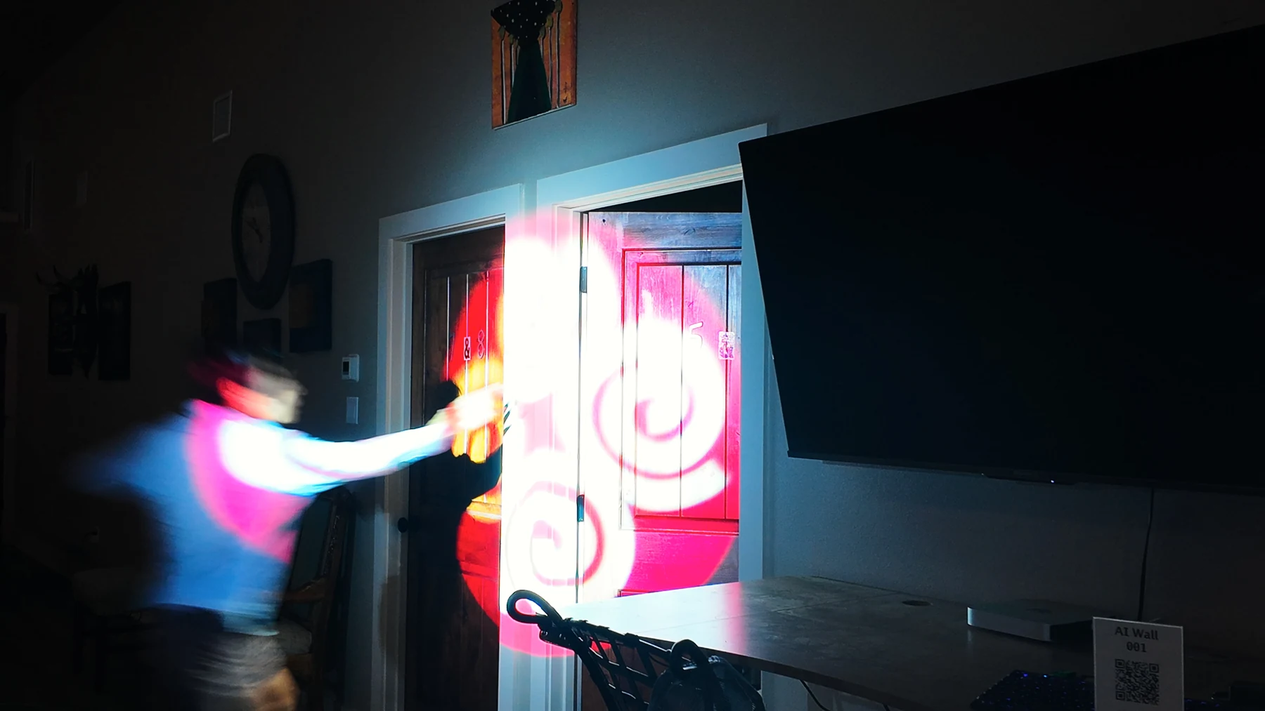 A player reaching toward an illuminated interactive display.